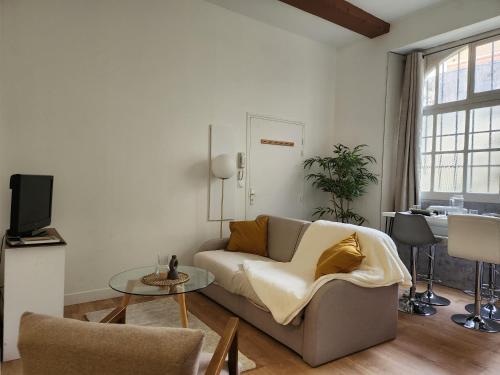 a living room with a couch and a table at L'aT3lier d'Orthez in Orthez