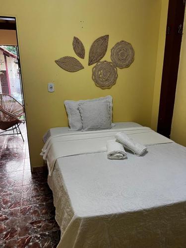 a bedroom with a bed with towels on it at CASA DE PRAIA CAJUEIRO ALTER in Alter do Chao