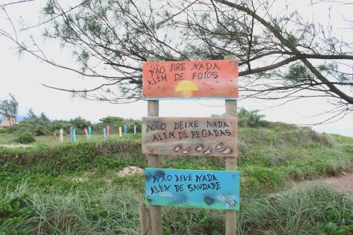 a sign that says no tire mud and may be rocks at Pousada Recanto Beach House - Cabo Frio - RJ- Unamar- Cond Florestinha - 1 min a pé da praia in Tamoios