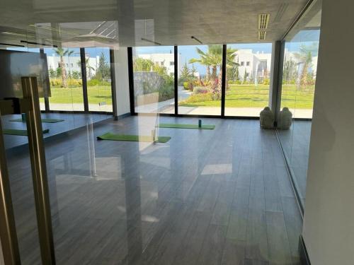 an empty room with glass doors and a room with yoga mats at Retreat, block B1, unit7 in Küçükerenköy