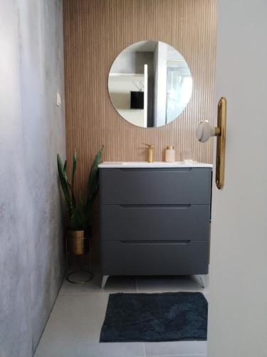 a bathroom with a sink and a mirror at Favinha Rooftop in Machico
