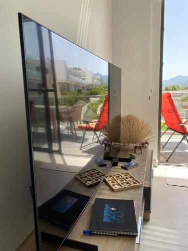 a room with a glass table and a mirror at Retreat, block B1, unit15 in Küçükerenköy