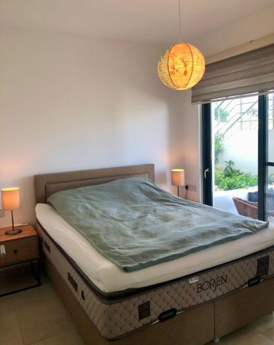 a bed sitting in a room with a window at Retreat, block B2, unit 6 in Ayios Nikolaos