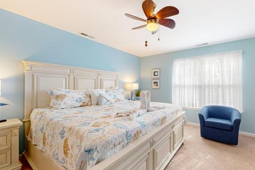 a bedroom with a bed with a ceiling fan and a blue chair at Bayville Shores --- 35729 Coleman Ave in Selbyville