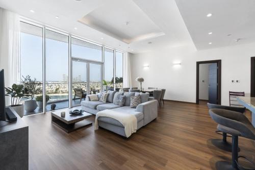 a living room with a couch and a table at Emerald at Tiara Beach Residences with Atlantis views in Dubai