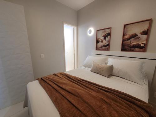 a bedroom with a large white bed with two pillows at Toscana Asa norte · Kit aconchegante na Asa norte in Brasilia