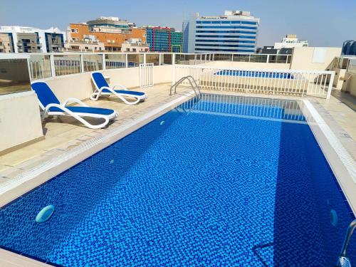 a swimming pool on the roof of a building at Elegant Fresh 1BR with Heated Pool, just steps from Mall, Restaurants & Fitness center in Dubai
