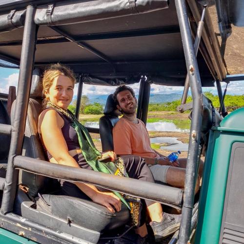 a man and a woman sitting in the back of a vehicle at Batu's Safari lodge Udawalawe in Udawalawe