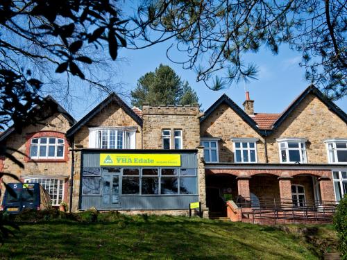 a building with a sign in front of a house at YHA Edale Activity Centre in Edale