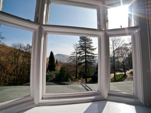 a window with a view of a mountain view at YHA Edale Activity Centre in Edale