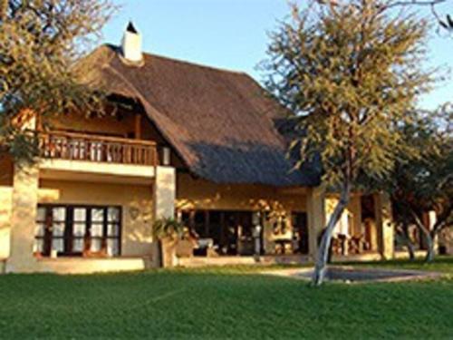 a large house with a gambrel roof at Farm stay in the heart of the Kalahari Namibia- serviced luxury self catering accommodation in Gobabis