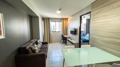 a living room with a couch and a table at Beach Class Convention - Flats em Boa Viagem por Yolo in Recife