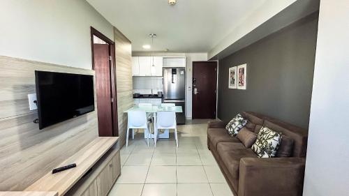 a living room with a couch and a table at Beach Class Convention - Flats em Boa Viagem por Yolo in Recife