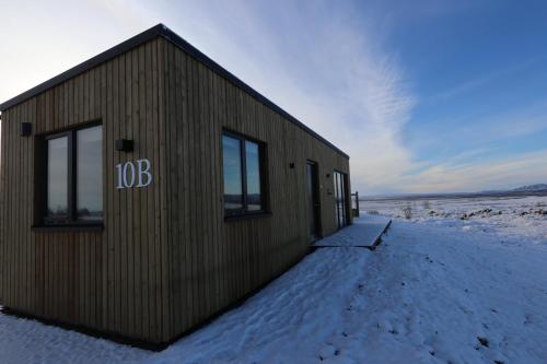 a building with the number on it in the snow at Blue View Cabins in Reykholt