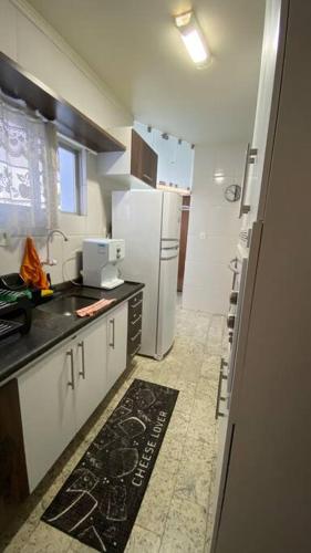 a kitchen with a white refrigerator and a counter top at Ap da Auri in Petrolina