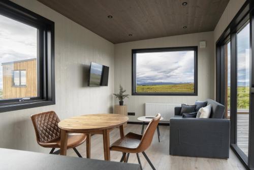 a living room with a table and a couch at Blue View Cabins in Reykholt
