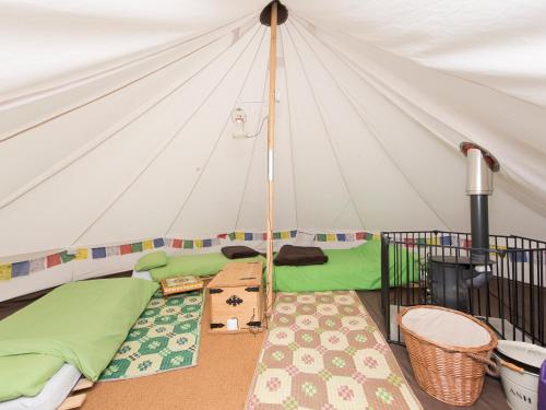 a room with a tent with a bed in it at YHA New Forest in Burley