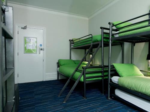 a room with two bunk beds and a door at YHA New Forest in Burley