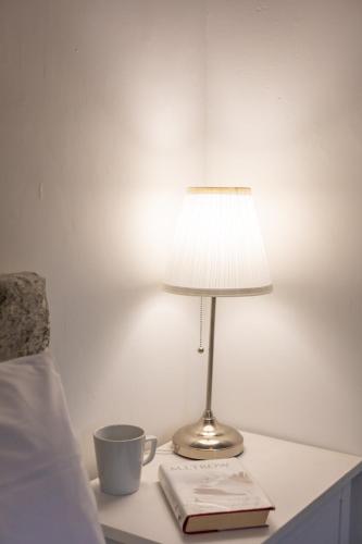 a lamp sitting on a table next to a bed at Glebe Street Apartment in Fife