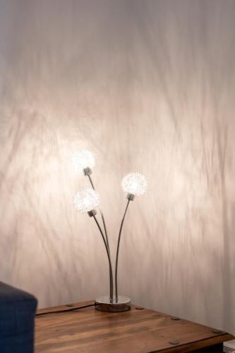 two white flowers in a vase on a table at Glebe Street Apartment in Fife
