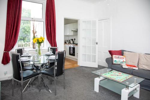 a living room with a table and a couch at Glebe Street Apartment in Fife