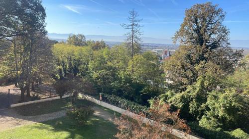 a view of a garden with trees and a fence at Villa Favorita in Bra