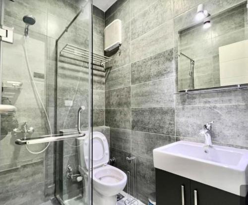 a bathroom with a toilet and a sink and a shower at Imperial Beach Resort in Hurghada