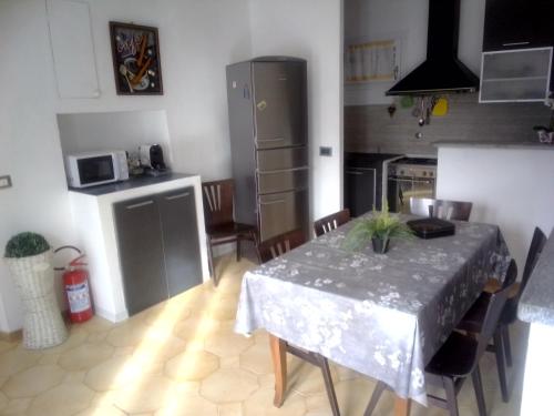 a kitchen with a table with a table cloth on it at Casa diana in Venaria Reale