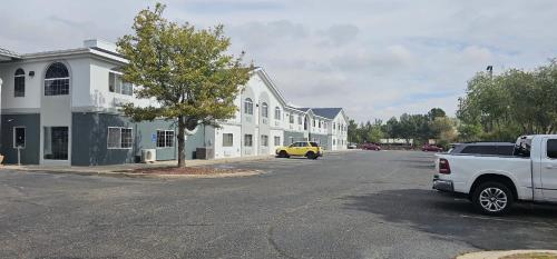 a white truck parked on a street next to a building at Quality Inn & Suites Roswell North in Roswell