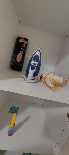 a shelf with a book and other items on it at Nenita Home in Nénita