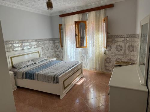 a bedroom with a bed and a tub in a room at Dohri Apartments in Monte ʼArrouit