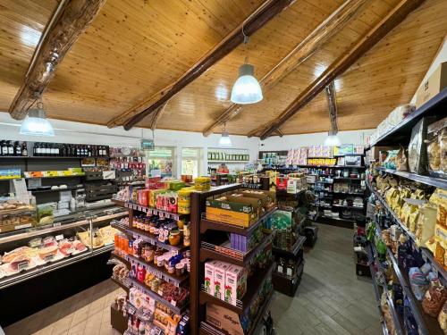 a store aisle of a grocery store filled with food at Hostel & Glamping Santa Fortunata in Sorrento