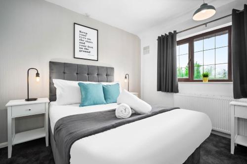 a bedroom with a large white bed and a window at Three Bedroom House - Garden Space - Parking Included - Netflix Access - Parking - 74B in Walsall Wood