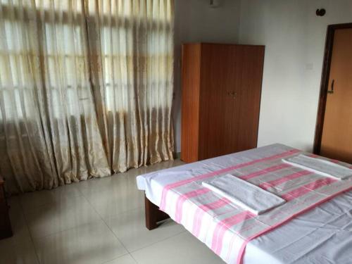 a bedroom with a bed with a blanket on it at Villa 133 - 2 bed rooms in Dodanduwa