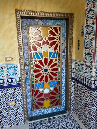 a door with a mosaic design on it in a room at Villa Barba Luxor in Luxor