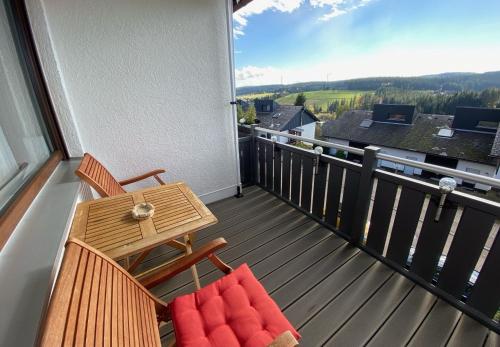a balcony with a table and chairs and a view at Klug in Schonach