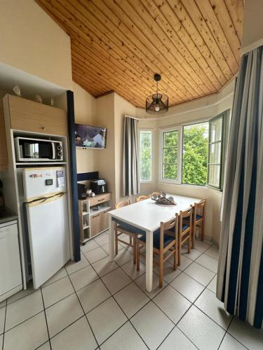 une cuisine avec une table et une salle à manger dans l'établissement Duplex lumineux, à Saint-Jean-dʼOrbetiers