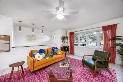 a living room with a couch and a chair at 4bd Gator Grove Villa - Backyard - Games - Near UF in Gainesville