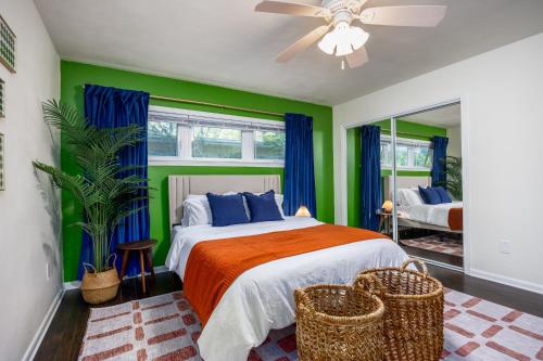 a bedroom with a bed with blue and green walls at 4bd Gator Grove Villa - Backyard - Games - Near UF in Gainesville
