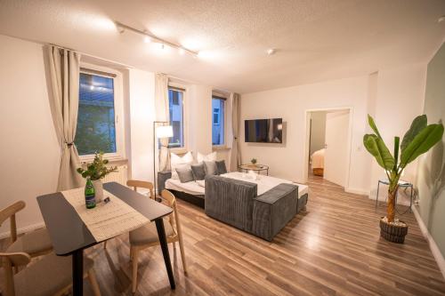 a living room with a couch and a table at RR - Spacious Apartments - Central - Parking in Magdeburg