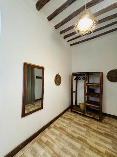 a room with white walls and a mirror at Z-Breeze Zanzibar in Kiwengwa