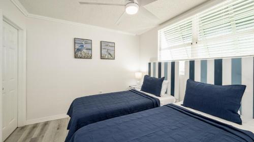 a bedroom with two beds and a window at The Larks Landing by Last Key Realty in Key West