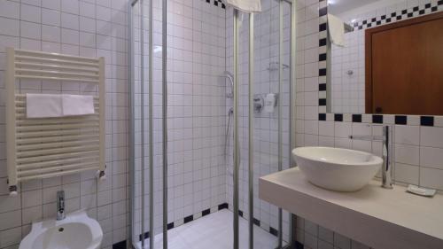 a bathroom with a sink and a shower and a toilet at Best Western Hotel Crimea in Turin