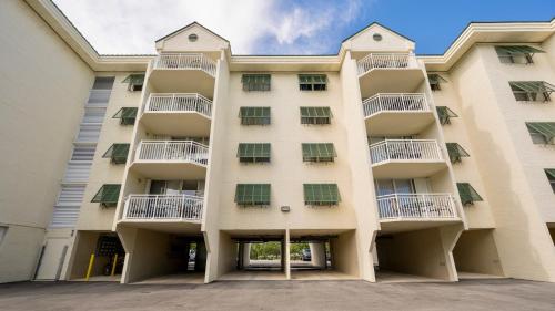 an apartment building with balconies on it at The Larks Landing by Last Key Realty in Key West
