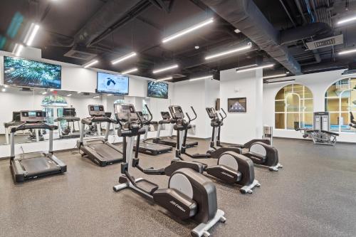 a gym with rows of tread machines in a room at Calypso Resort Tower 3 by Panhandle Getaways in Panama City Beach