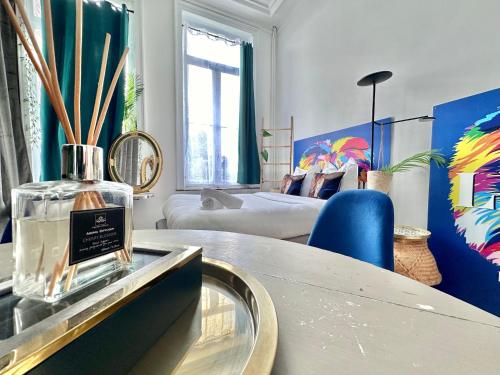 a room with a bottle of perfume on a counter at 05 -BALI Style Room - Tourcoing in Tourcoing