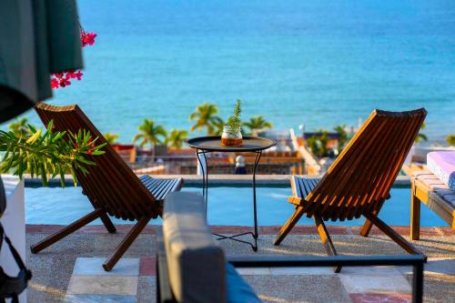 two chairs and a table with a view of the ocean at Casa Pancha Puerto Vallarta Centro - Adults Only in Puerto Vallarta
