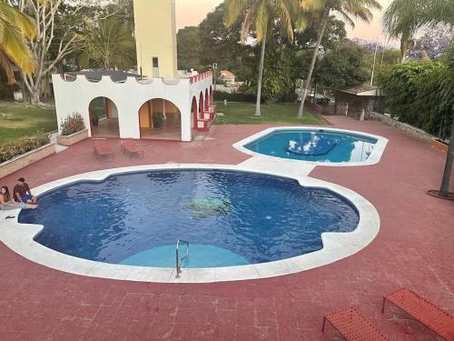 a large pool of water on a red brick patio at Villita en la floresta in Ajijic