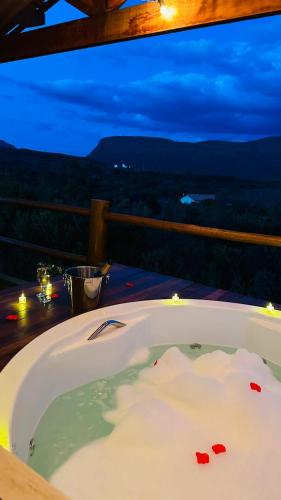 a bath tub sitting on a table with a view at Vila Verde in Palmeiras