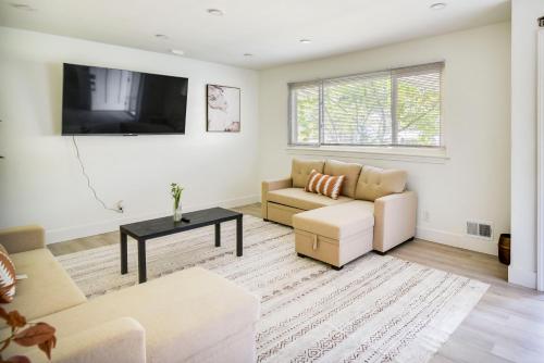 a living room with a couch and a tv at Pet-Friendly Norfolk Retreat about 7 Mi to Beach! in Virginia Beach